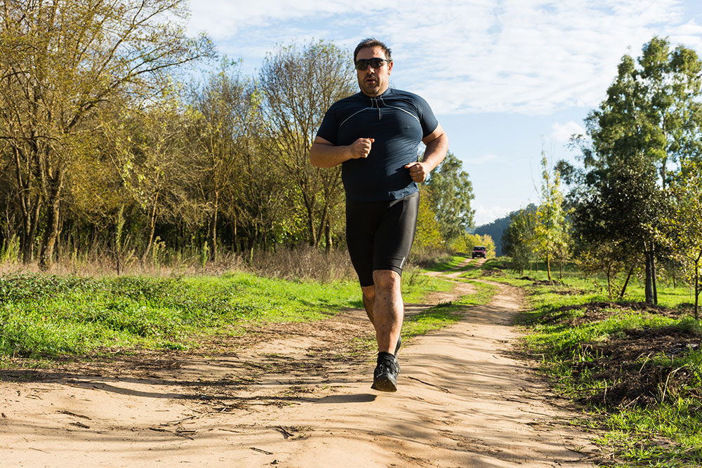 Overweight man jogs to help his sleep apnea.